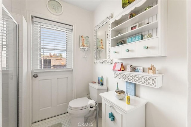 bathroom featuring toilet, tile patterned flooring, and walk in shower