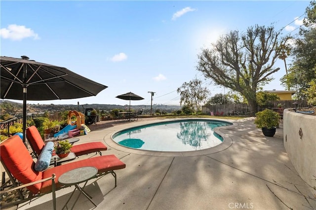 view of pool featuring a playground and a patio