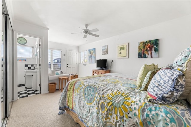 bedroom featuring ceiling fan, connected bathroom, ornamental molding, and carpet floors