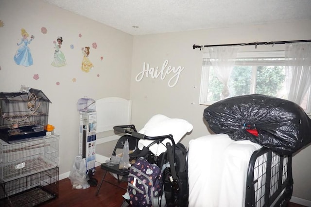 bedroom featuring hardwood / wood-style floors and a textured ceiling