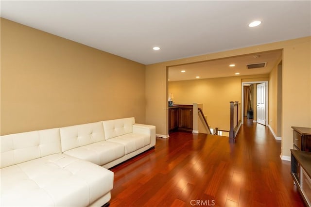 living room featuring baseboards, wood finished floors, visible vents, and recessed lighting