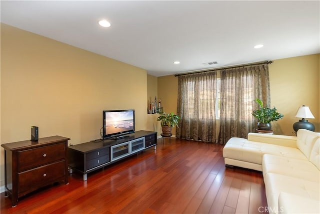 living area with dark wood-type flooring, recessed lighting, and visible vents