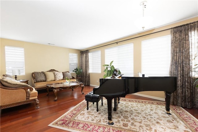 sitting room with dark wood-style floors and visible vents