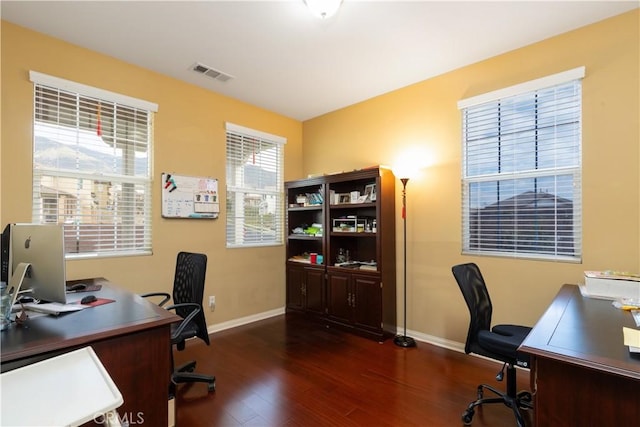 office area featuring dark wood-style floors, baseboards, and visible vents