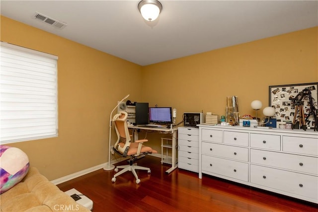 home office with dark wood-style flooring, visible vents, and baseboards