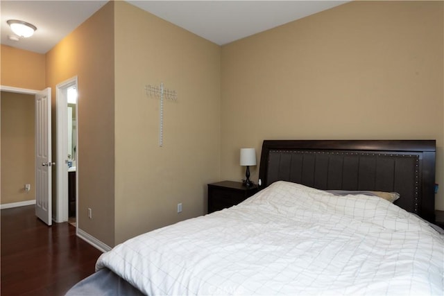 bedroom featuring dark wood-style floors and baseboards