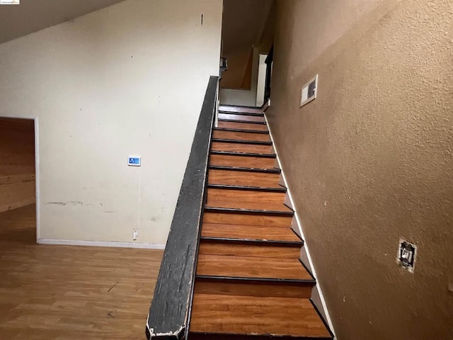 staircase featuring hardwood / wood-style floors