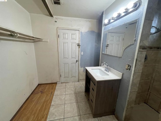 bathroom with vanity, tile patterned floors, and walk in shower