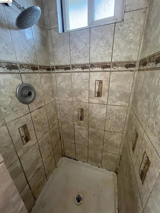 bathroom with tiled shower