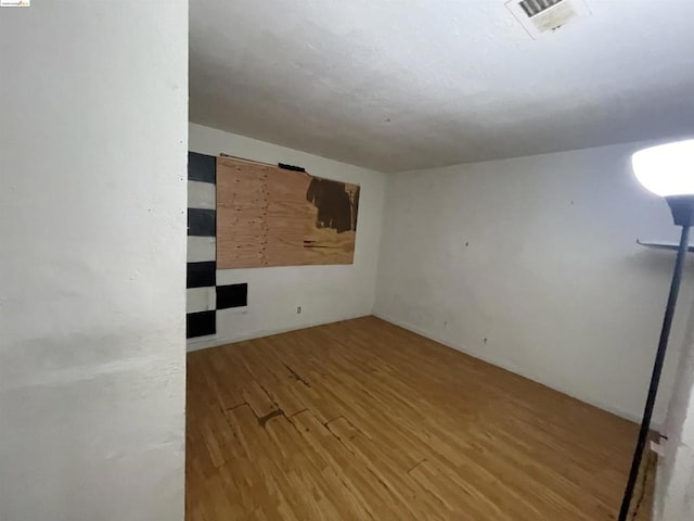 spare room featuring hardwood / wood-style floors