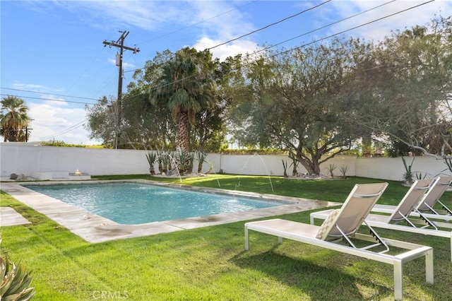 view of pool with pool water feature and a lawn