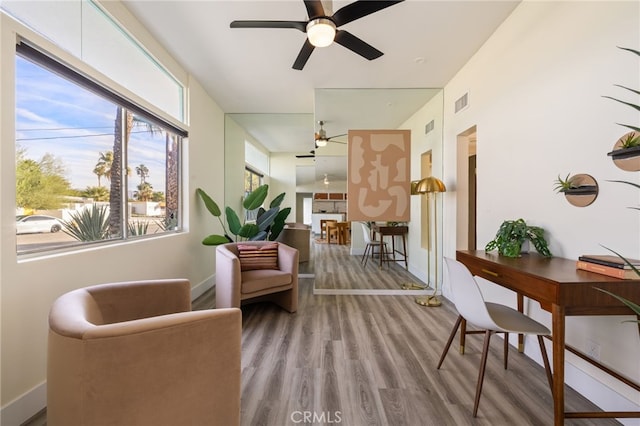 living area featuring ceiling fan and light hardwood / wood-style flooring