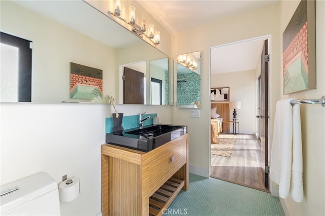 bathroom with toilet, tile patterned floors, and vanity