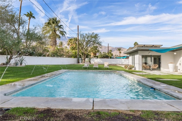 view of pool featuring pool water feature and a yard