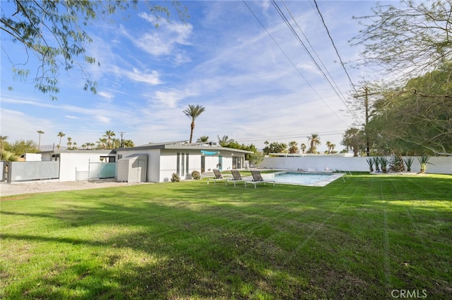 view of yard with a fenced in pool