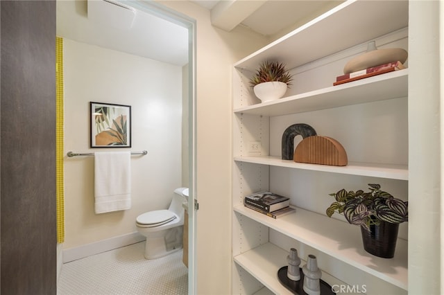 bathroom with toilet and tile patterned flooring