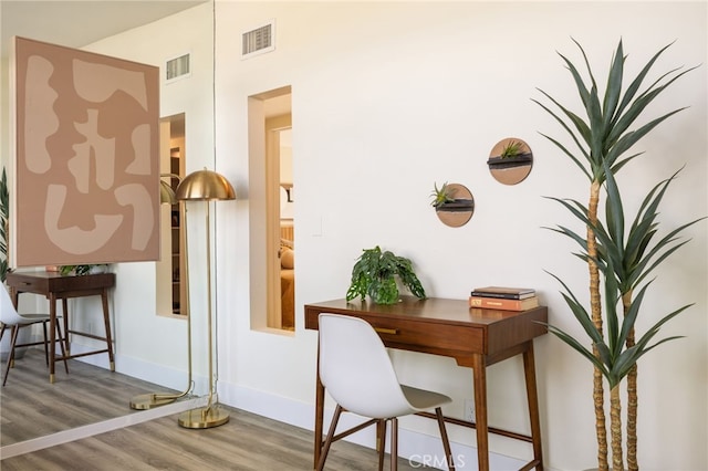 office with dark hardwood / wood-style flooring