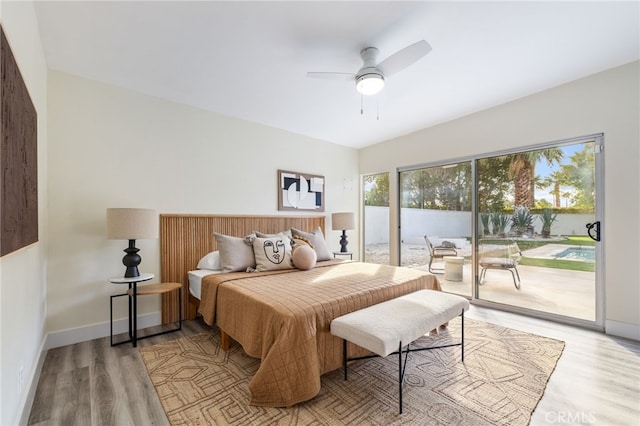 bedroom featuring access to outside, ceiling fan, and light wood-type flooring