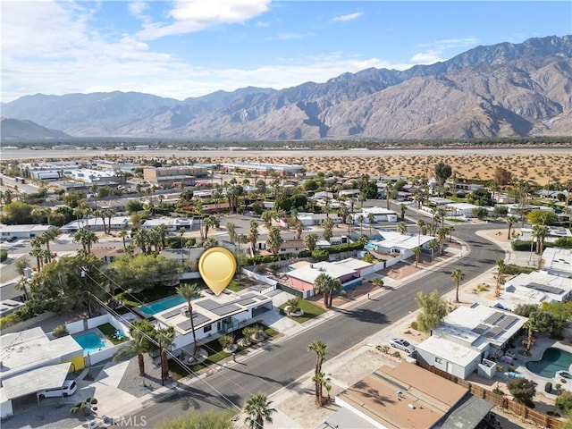 birds eye view of property with a mountain view