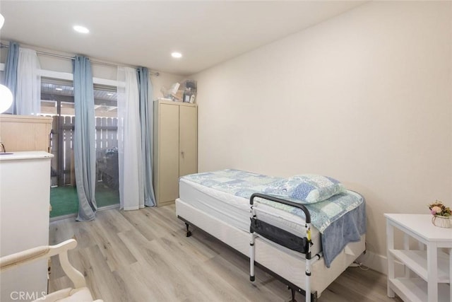 bedroom featuring access to outside and light hardwood / wood-style floors