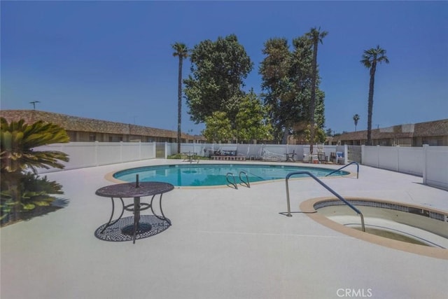 view of pool featuring a patio area and a community hot tub