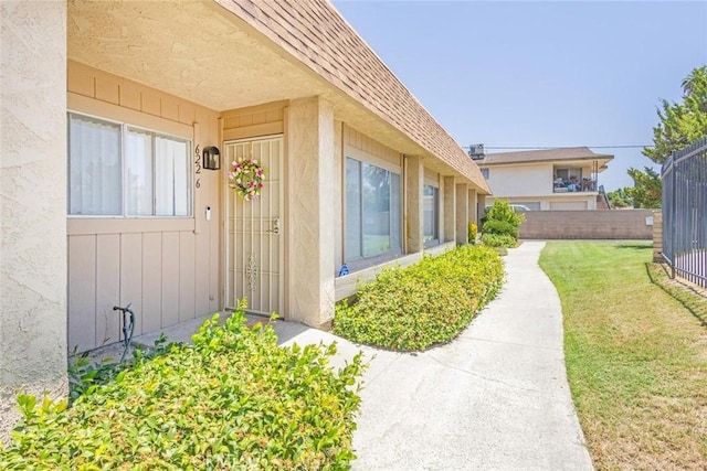 property entrance with a lawn