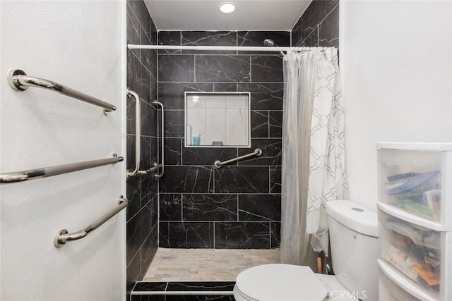 bathroom with toilet and walk in shower