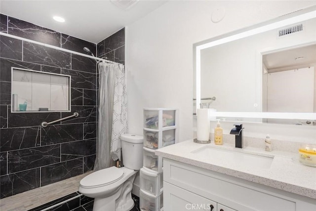 bathroom with a shower with shower curtain, vanity, and toilet