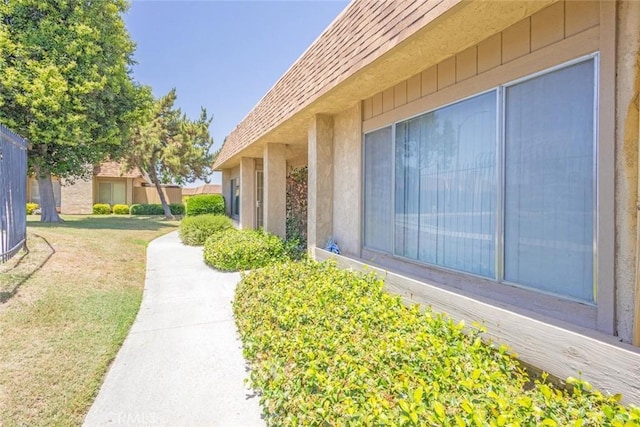 view of property exterior featuring a lawn