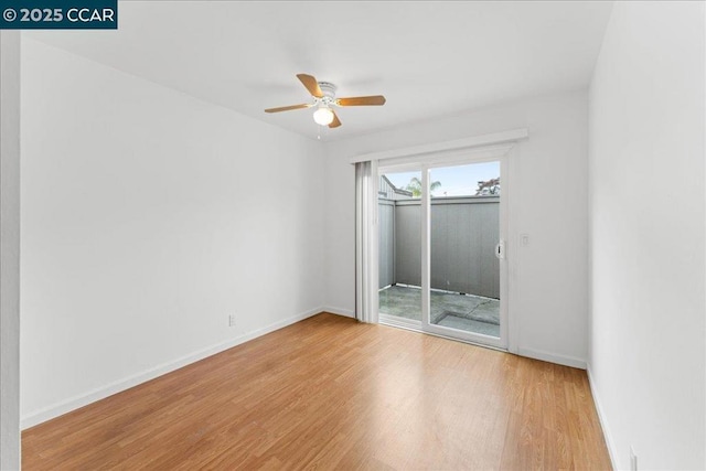 empty room with ceiling fan and light hardwood / wood-style floors