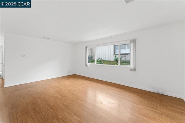 spare room featuring light hardwood / wood-style floors