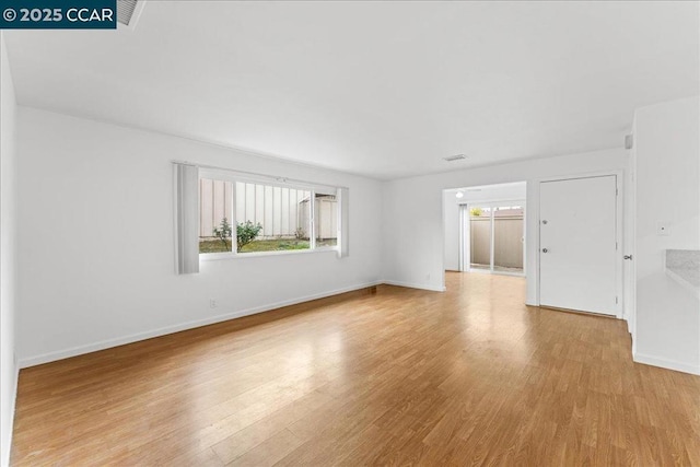 spare room with light hardwood / wood-style flooring