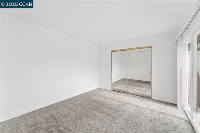 unfurnished bedroom with a closet and carpet