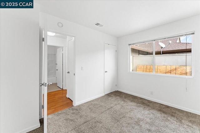 unfurnished bedroom with carpet flooring and a closet