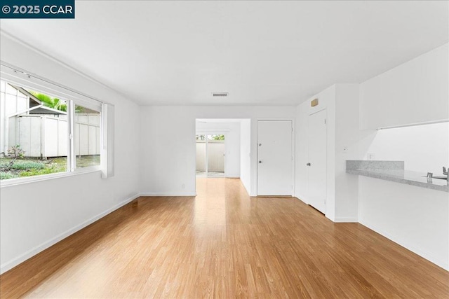 unfurnished living room with light hardwood / wood-style floors