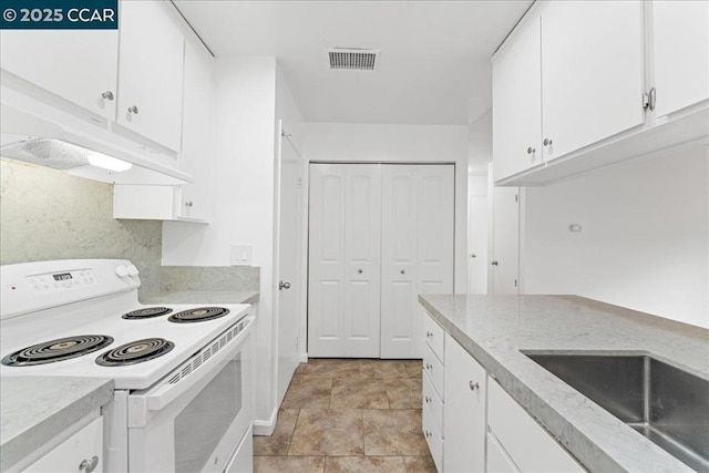 kitchen featuring white cabinetry, sink, and electric stove