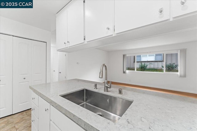 kitchen with sink and white cabinets