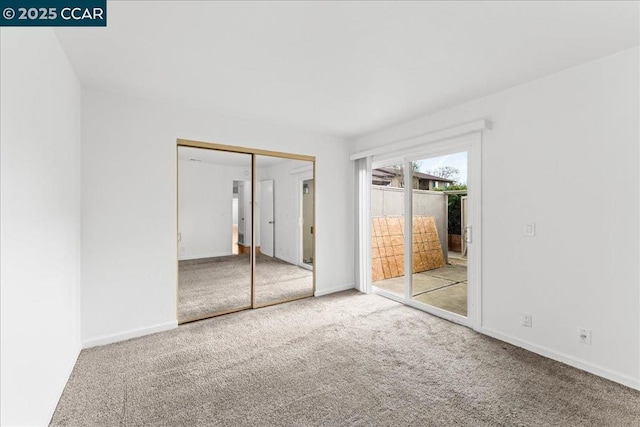 unfurnished bedroom featuring carpet floors, a closet, and access to outside