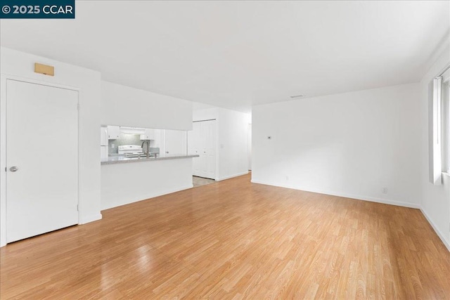 unfurnished living room with light hardwood / wood-style flooring