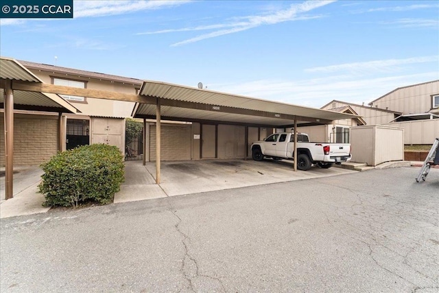 view of parking / parking lot featuring a carport