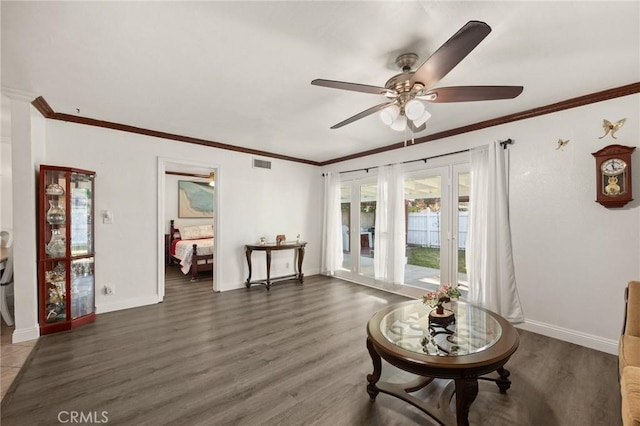 interior space featuring ceiling fan, crown molding, and dark hardwood / wood-style floors