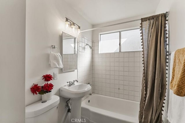 bathroom with shower / bath combo and toilet