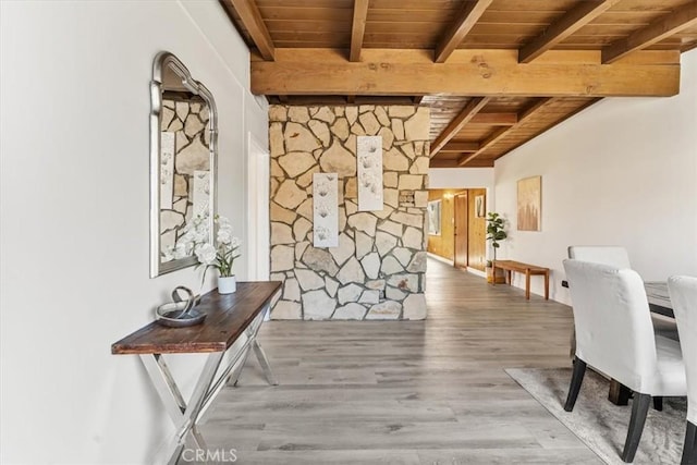 hallway featuring hardwood / wood-style floors, beam ceiling, and wooden ceiling