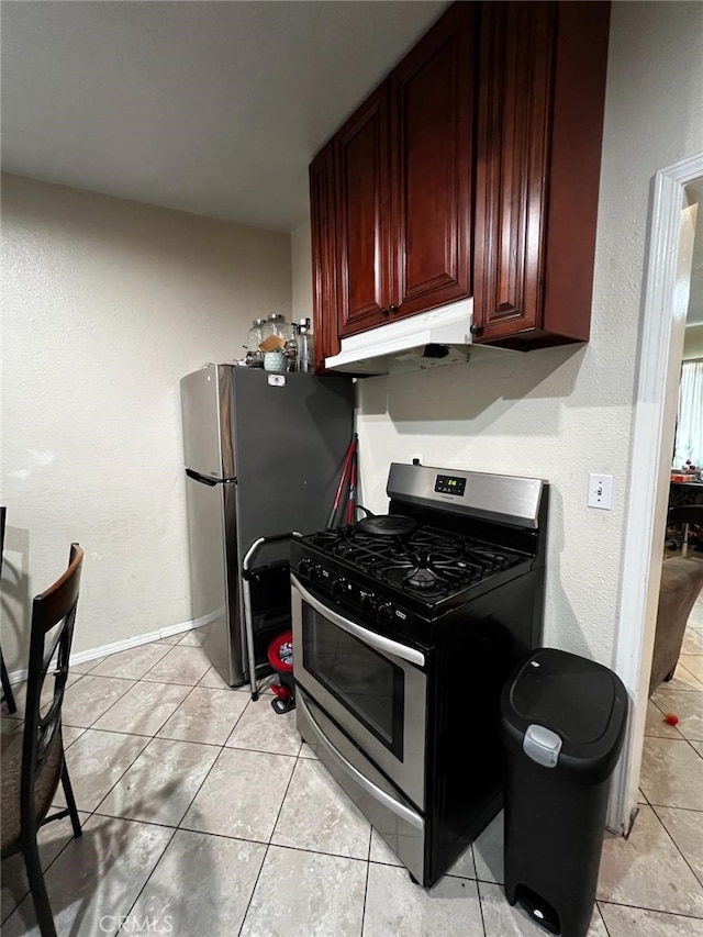 kitchen with light tile patterned flooring and stainless steel appliances