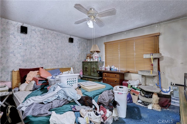 bedroom with a textured ceiling and ceiling fan