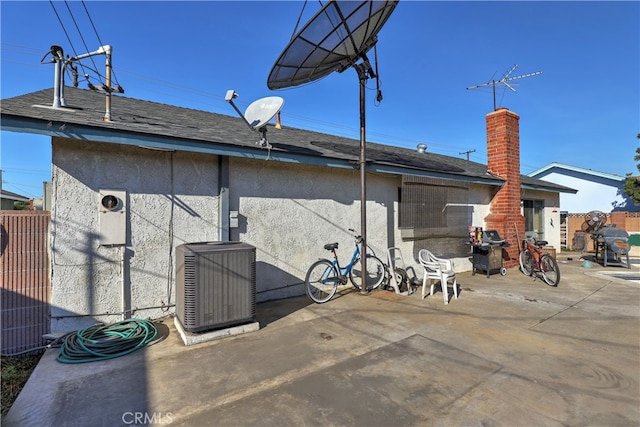 rear view of house with a patio and central AC unit