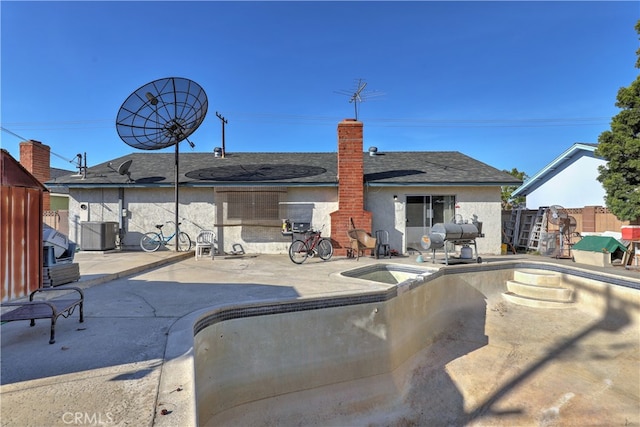 back of house featuring central AC unit and a patio area