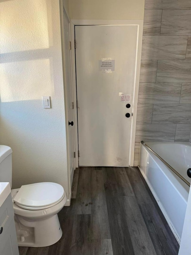 full bathroom featuring toilet, vanity, shower / bath combination, and hardwood / wood-style floors