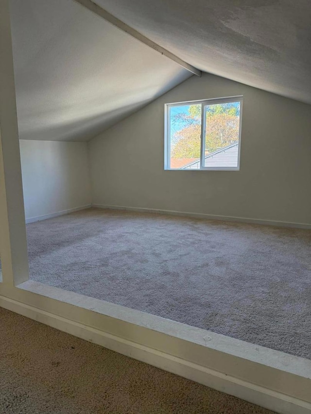 bonus room featuring carpet floors and lofted ceiling