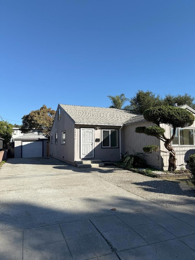 view of front of house featuring a garage and an outdoor structure